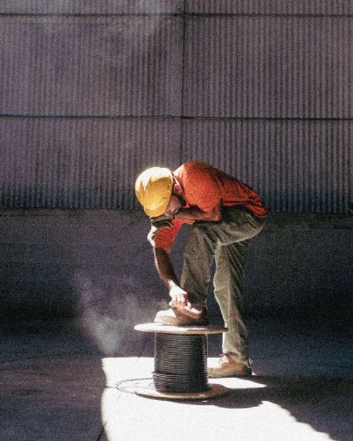 worker brushing off shoes